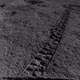 The Yutu 2 rover looking back on its progress, with two of its wheels visible in the bottom corners.